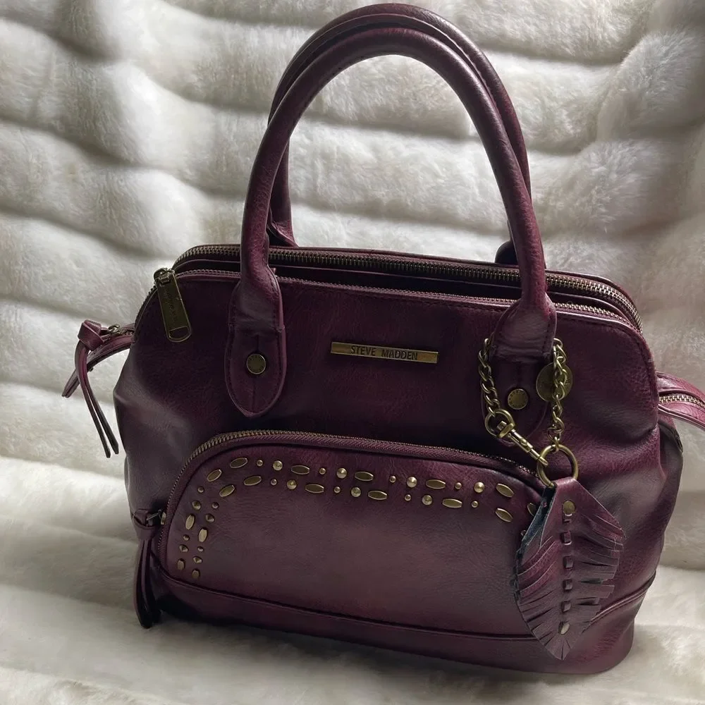 Steve Madden burgundy faux leather satchel with rustic studs accent.
